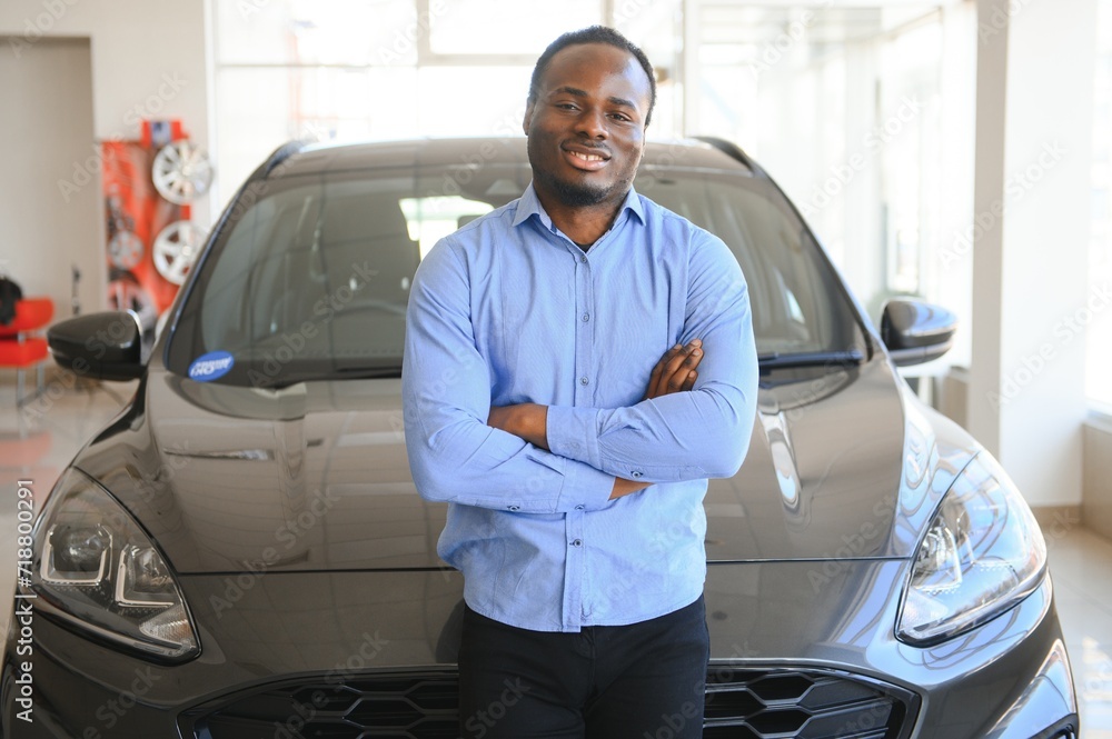 Happy Car Buyer, New Car Owner Concept. Portrait Of Excited Young African American Guy In Dealership Showroom Happy Car Buyer, New Car Owner Concept. Portrait Of Excited Young African American Guy In Dealership Showroom