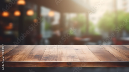 Photo of empty wooden table and restaurant sign inside blurry glass window. Abstract background mockup , wallpaper and background. © Nawarit