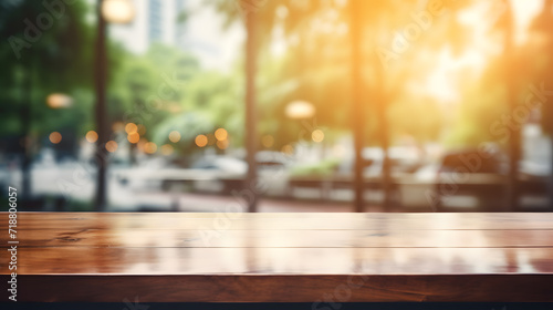 Photo of empty wooden table and restaurant sign inside blurry glass window. Abstract background mockup , wallpaper and background.