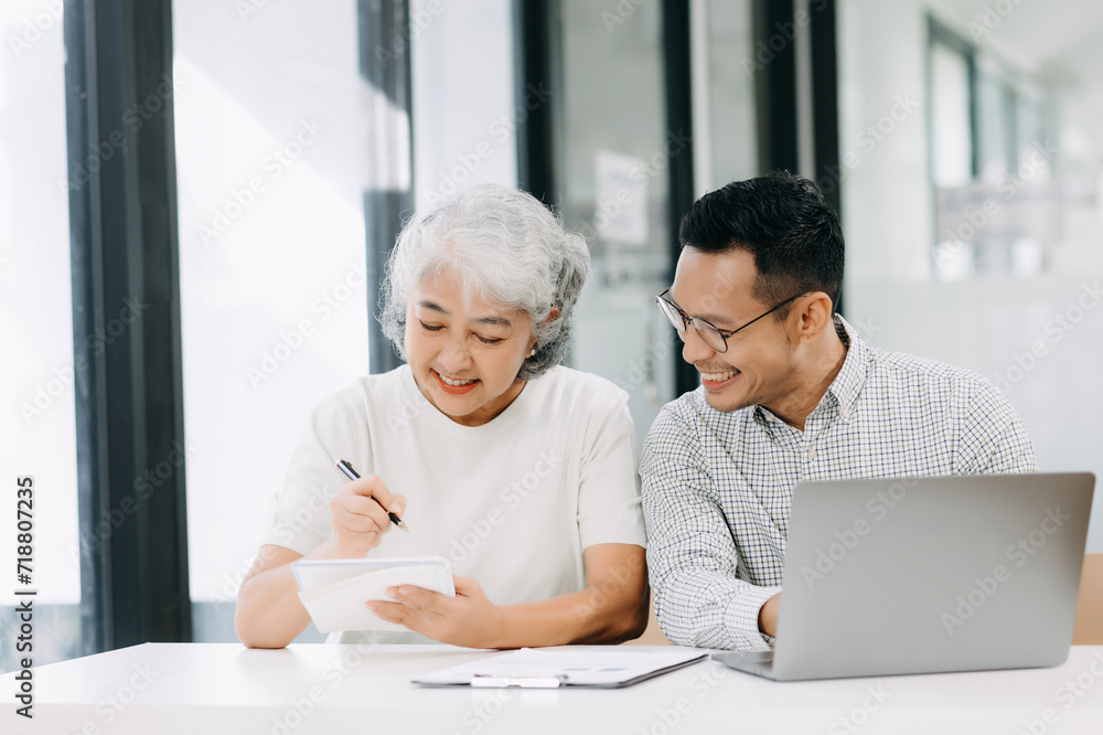 Fototapeta premium Portrait of success Asian business people working together in office. Couple teamwork startup concept