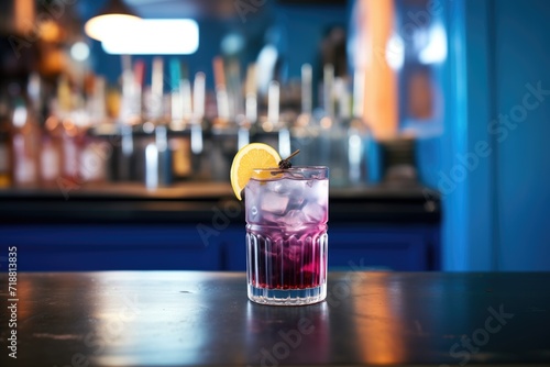 blackcurrant soda on a bar counter with blue backlight © primopiano