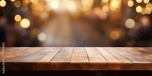 Blank wooden table in bokeh cafe, ready for your merchandise. Abstract backdrop.