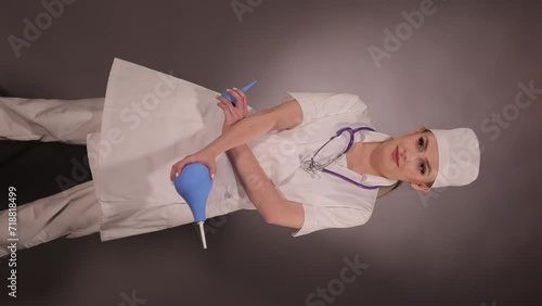 Emotional young woman doctor nurse in a white coat and hat