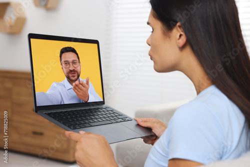 Long distance love. Woman having video chat with her boyfriend via laptop at home