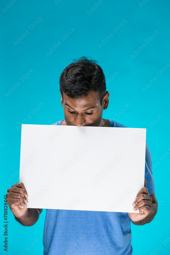 Indian man holding up a banner. Indian man holding up a banner.