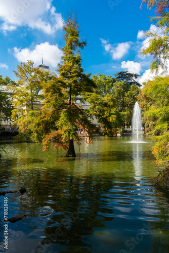 Pond with trees in front of the crystal palace in the park of El retiro. Madrid - Spain