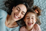Top view of a mother and her daughter laughing cheerfully