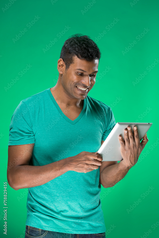 Indian man using a tablet PC Indian man using a tablet PC
