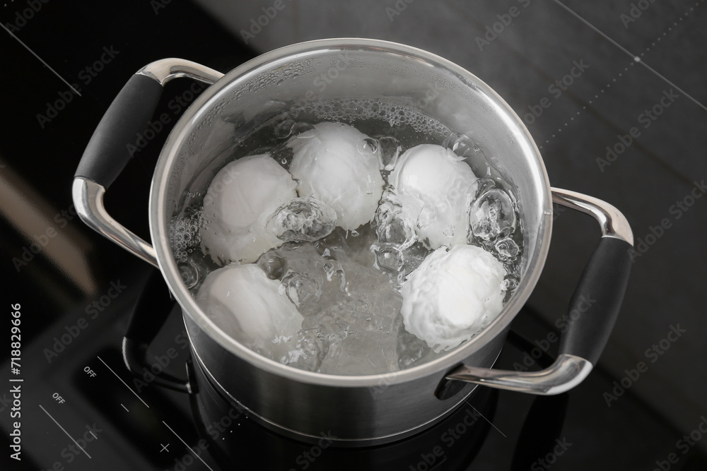 Chicken eggs boiling in pot on electric stove, above view Chicken eggs boiling in pot on electric stove, above view