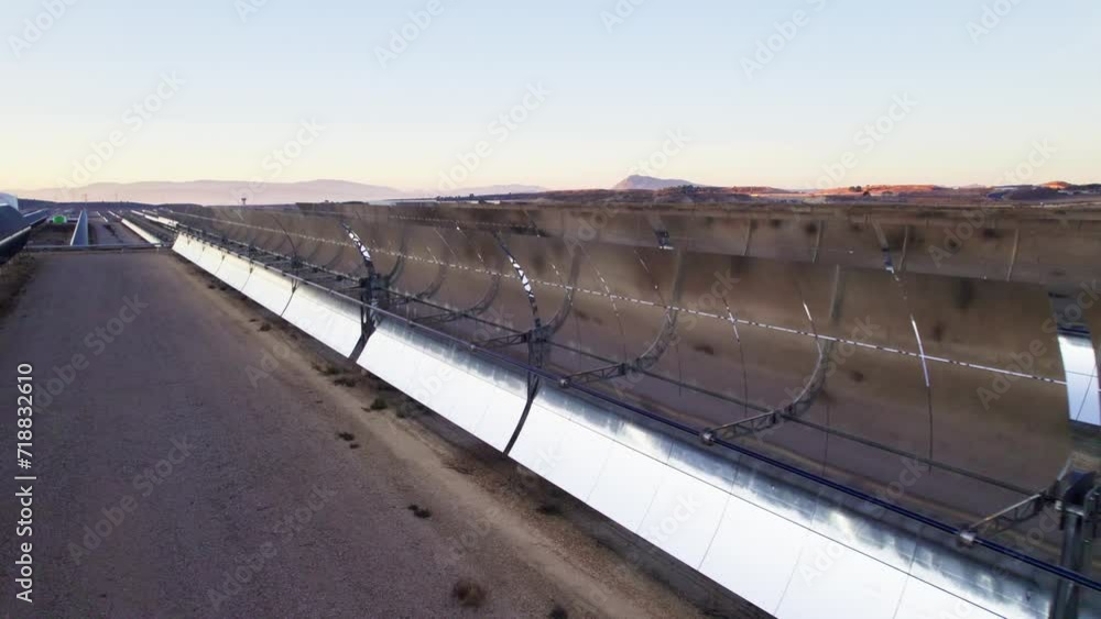 Solar thermal power plant at sunrise. Mirrors reflecting the sun, heating the water flowing through a metallic tube passing through a turbine that converts steam into electricity. Aerial video Solar thermal power plant at sunrise. Mirrors reflecting the sun, heating the water flowing through a metallic tube passing through a turbine that converts steam into electricity. Aerial video