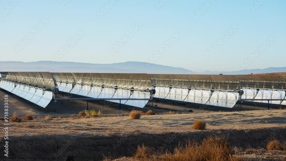 Solar thermal power plant at sunrise. Mirrors reflecting the sun, heating the water flowing through a metallic tube passing through a turbine that converts steam into electricity. Static video Solar thermal power plant at sunrise. Mirrors reflecting the sun, heating the water flowing through a metallic tube passing through a turbine that converts steam into electricity. Static video