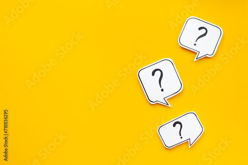 Ask and answer concept. Question marks on speech bubbles, top view
