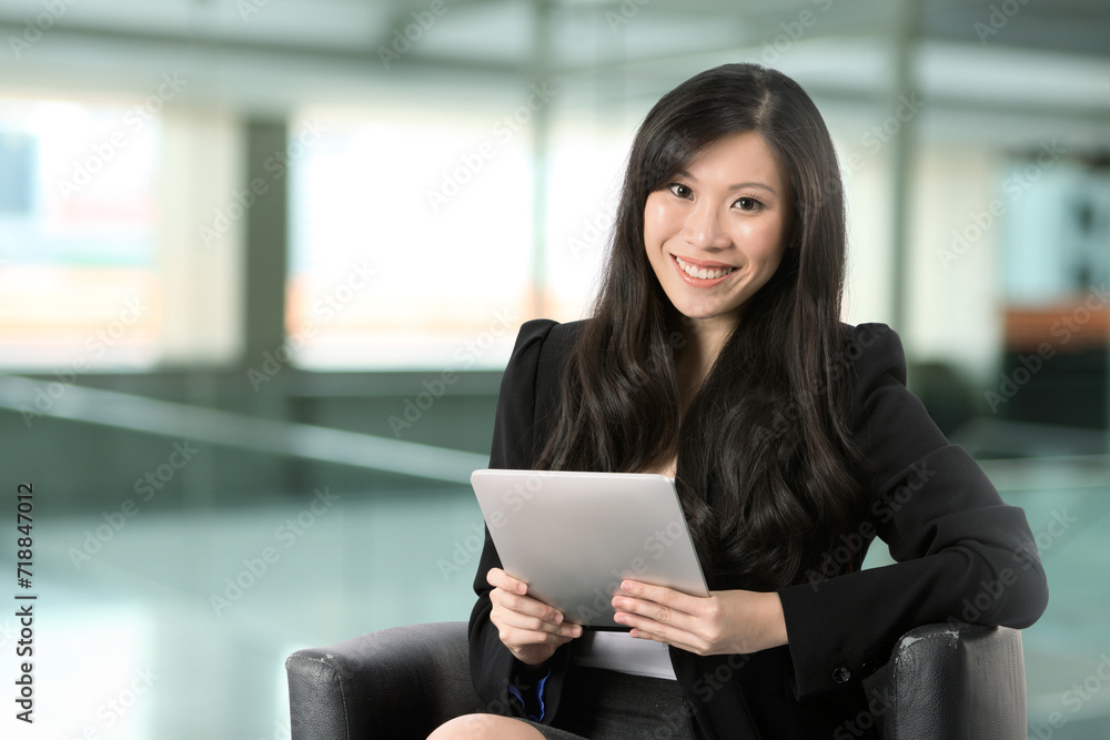 Chinese woman using a touch pad PC. Chinese woman using a touch pad PC.