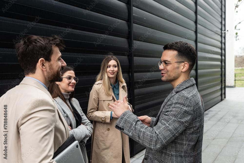 Group of young business people, job candidates standing in front of the office building waiting to be called to meeting with the employer. Businessmen and businesswomen waiting for human resources Group of young business people, job candidates standing in front of the office building waiting to be called to meeting with the employer. Businessmen and businesswomen waiting for human resources