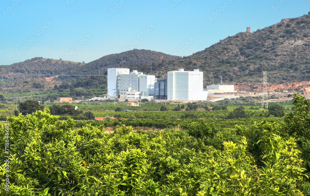 Wheat flour manufacturing mill in Almenara, Spain. Agricultural factory. Wheat flour mill production. Elevator for grain  and corn storage. Wheat flour plant in orange farm field. Agriculture industry