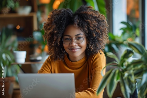 Afro-American woman working on laptop in home office