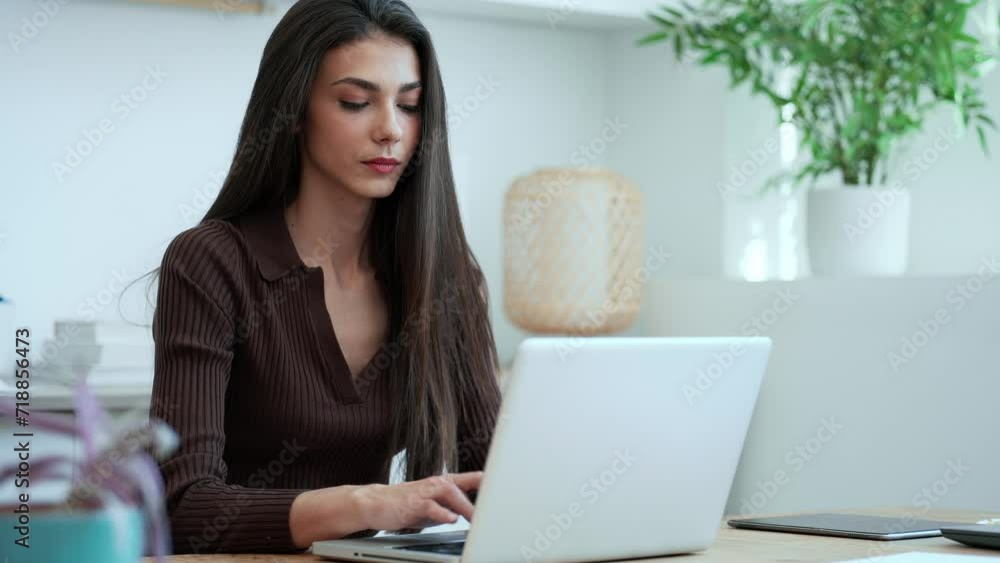 Video of elegant young business woman working with her laptop in a modern office. Video of elegant young business woman working with her laptop in a modern office.