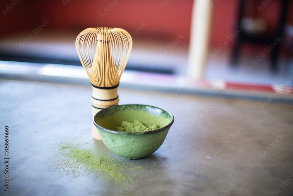 matcha powder beside a traditional bamboo whisk matcha powder beside a traditional bamboo whisk