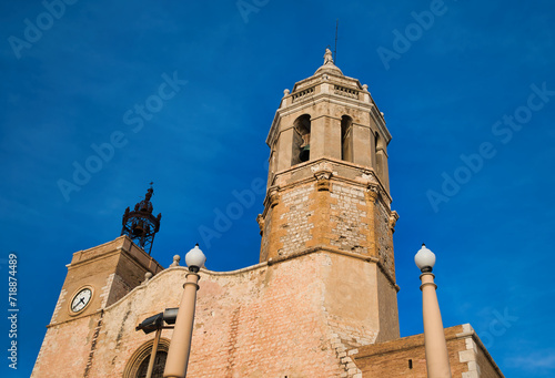 Church of San Bartolomé and Santa Tecla Its asymmetrical silhouette, on a hill in front of the beach, is one of the most characteristic images of the town of Sitges, Catalonia, Spain. photo