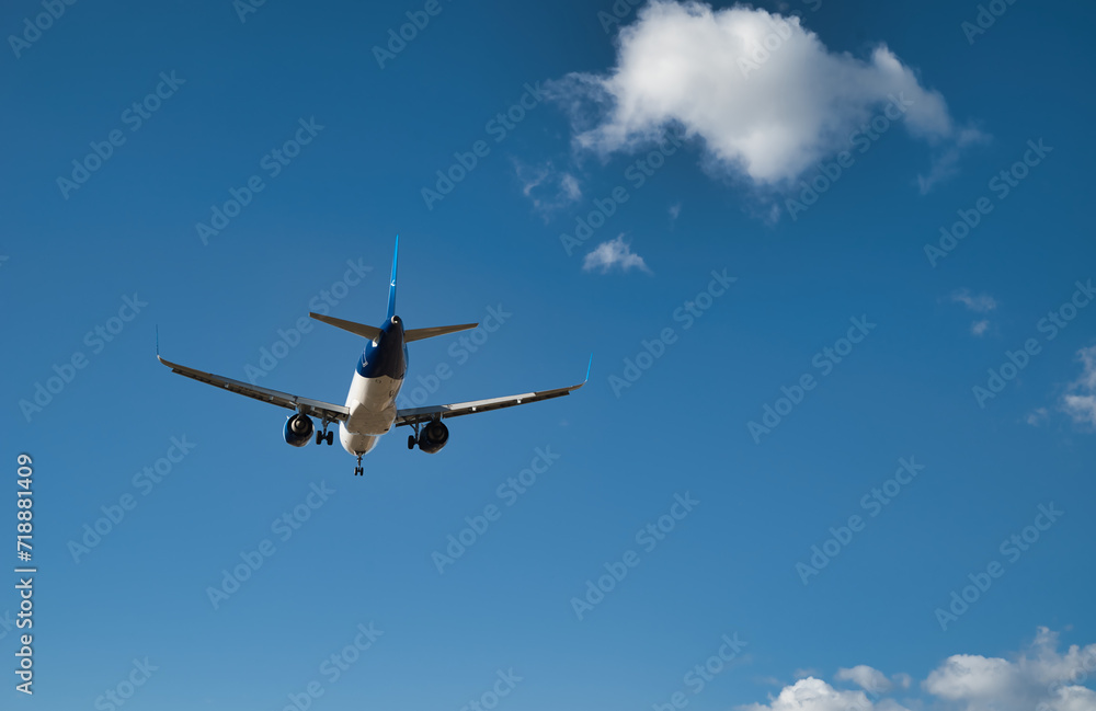 Passenger airplane, flying in the blue sky Passenger airplane, flying in the blue sky