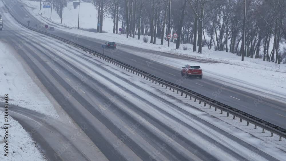 Traffic on highway during winter blizzard. Snowstorm on the road. Traffic on highway during winter blizzard. Snowstorm on the road.