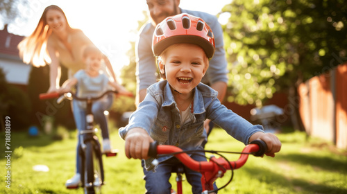 Smiling Child Learning to Ride a Bike with Parents