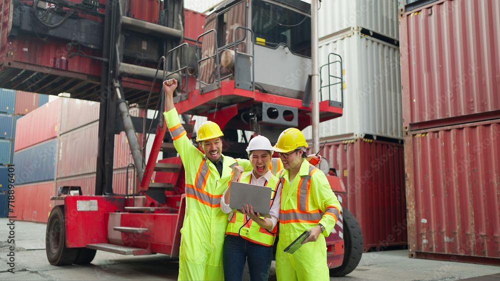 Team warehouse industrial workers in safety uniform celebrate shared working success at cargo container yard. Happy excited engineers industrial raising arm up to celebrate success or achievement Team warehouse industrial workers in safety uniform celebrate shared working success at cargo container yard. Happy excited engineers industrial raising arm up to celebrate success or achievement