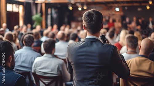 Public speaker in front of an audience in stock photography , Public speaker, audience, stock photography photo