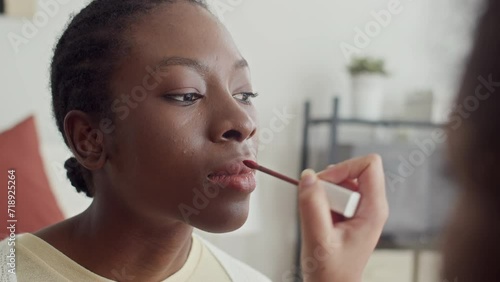 Wallpaper Mural Close up of girl applying lipstick on friends lips when doing makeup at home Torontodigital.ca