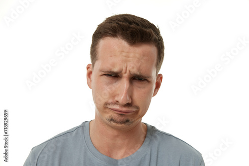 Portrait of frustrated young man on white background. sadness