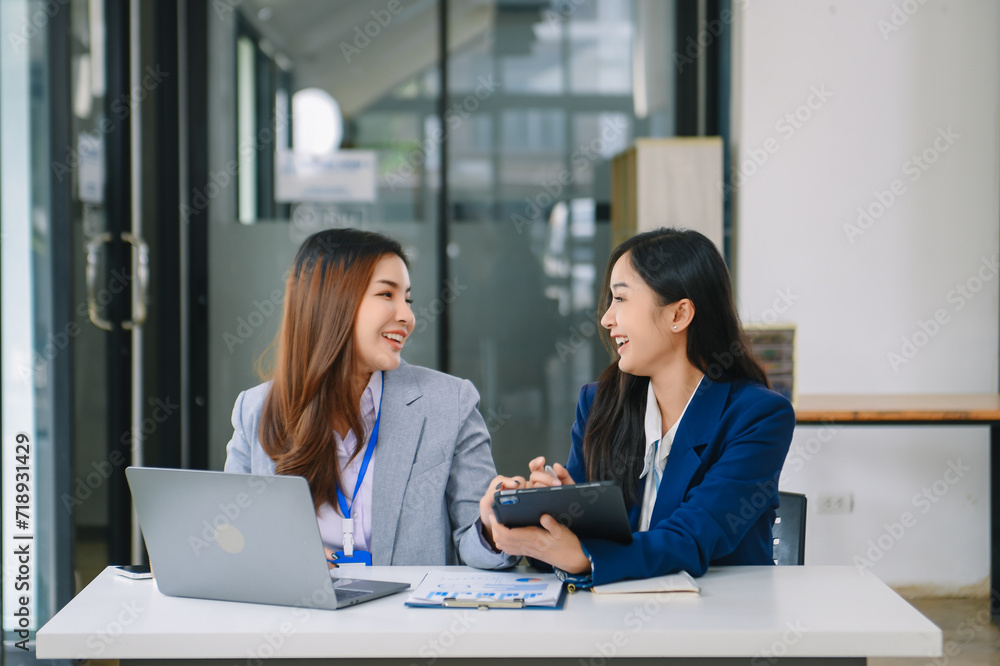 Asian business colleague business presents and explains and using laptop and tablet. Teamwork, financial marketing team, Asian business colleague business presents and explains and using laptop and tablet. Teamwork, financial marketing team,