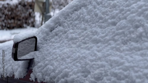 Close up of a car morror covered in snow photo