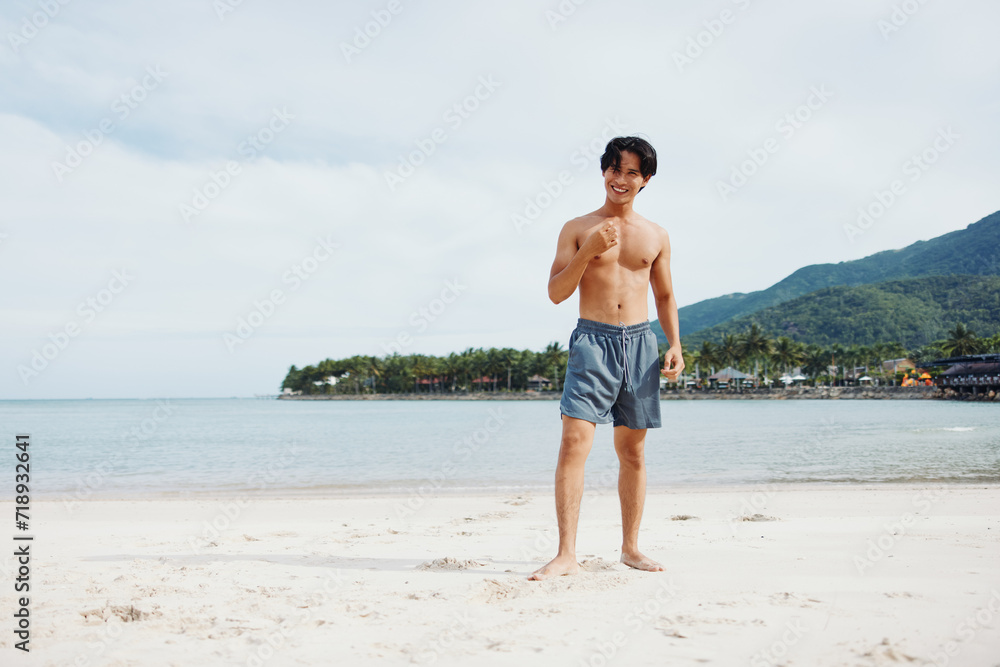 Active Asian Athlete Enjoying Beach Running for Fitness and Wellness in Summer Sunset