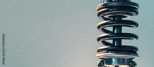 Close-Up of Car Suspension System isolated on flat background. Close-up view of a car shock absorber and spring assembly. photo