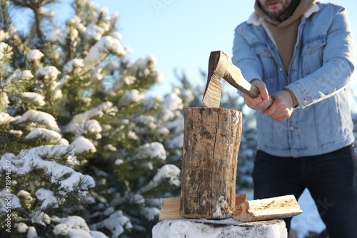 Wallpaper Mural Man chopping wood with axe outdoors on winter day, closeup. Space for text Torontodigital.ca