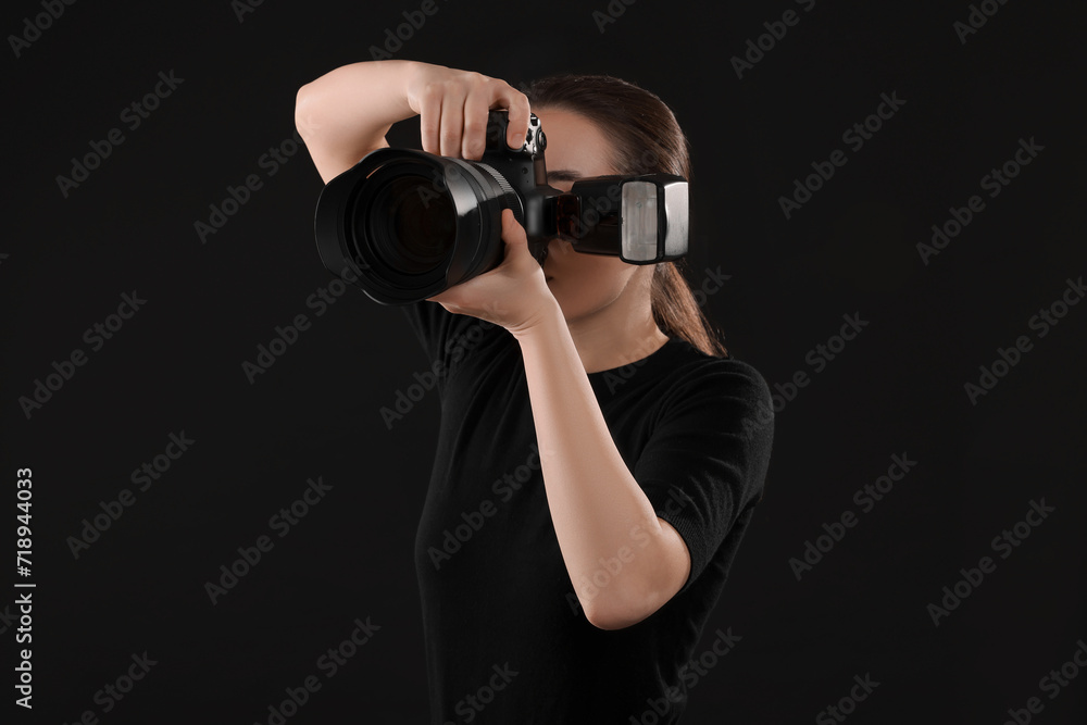 Professional photographer taking picture on black background Professional photographer taking picture on black background