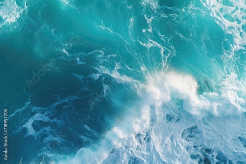 Aerial view of turquoise ocean water with splashes and foam.