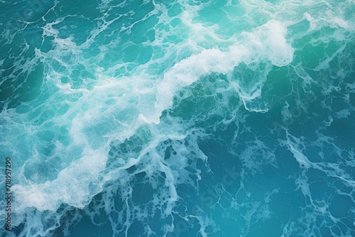 Aerial view of turquoise ocean water with splashes and foam.