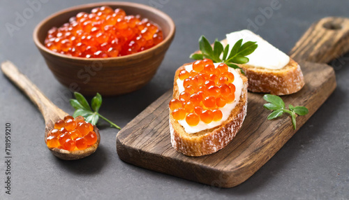 Red caviar on bread black background