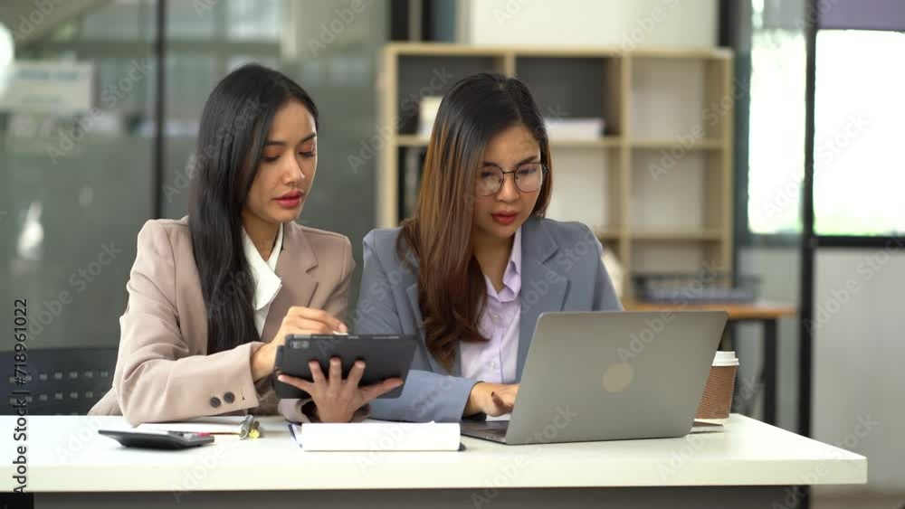 Business team using a calculator to calculate the numbers of statistic business profits growth rate on documents graph data, desk in the office. Business team using a calculator to calculate the numbers of statistic business profits growth rate on documents graph data, desk in the office.