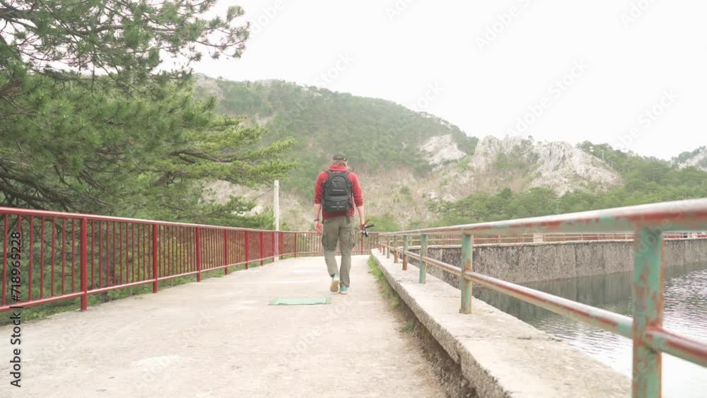A man walks along a fishing trail A man walks along a fishing trail