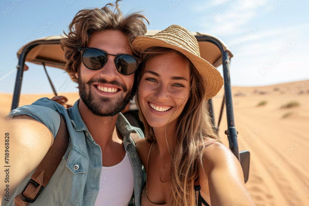 Young couple on an adventure tour, joyful tourists taking selfie with smart phone in desert