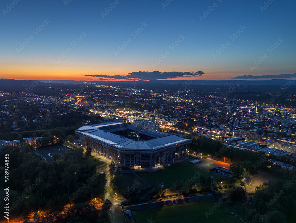 Aerial panoramic skyline cityscape of Kaiserslautern city and and stadium at night (blue hour). Rhineland-palatinate, Germany