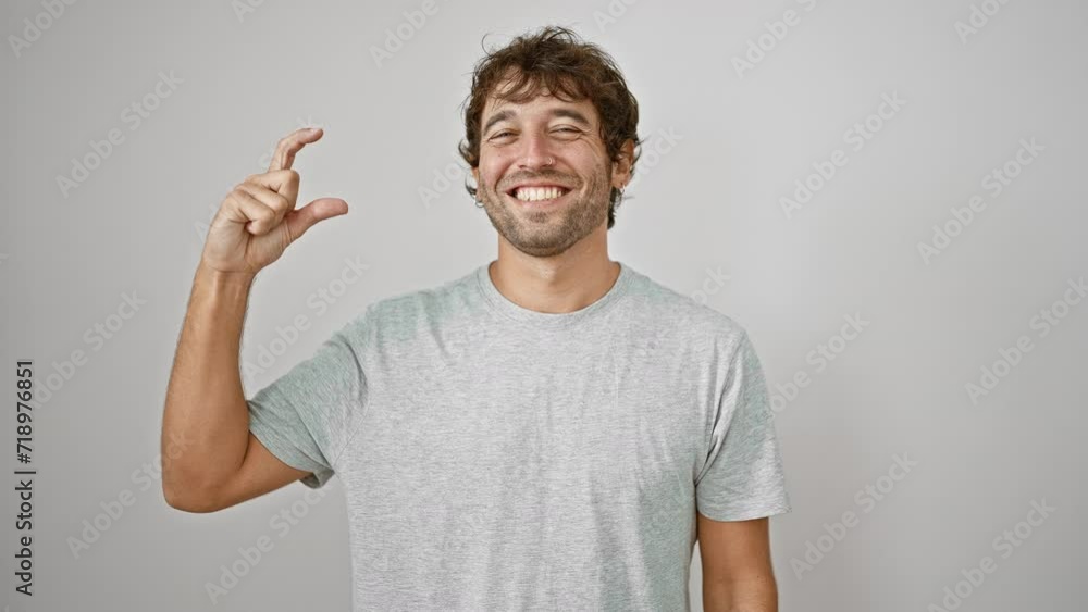 Confident young man in t-shirt gesturing small size concept with fingers, isolated on a white background Confident young man in t-shirt gesturing small size concept with fingers, isolated on a white background