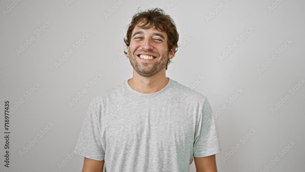 Handsome young man in casual t-shirt sticks his tongue out for a fun, positive expression of joy and happiness, isolated on white background. Handsome young man in casual t-shirt sticks his tongue out for a fun, positive expression of joy and happiness, isolated on white background.