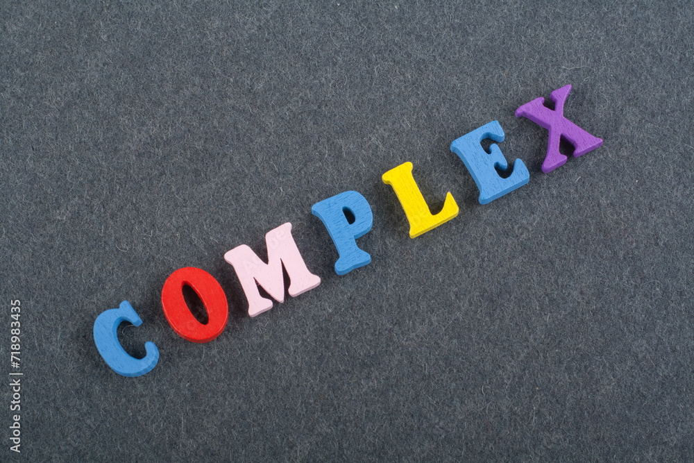 COMPLEX word on black board background composed from colorful abc alphabet block wooden letters, copy space for ad text. Learning english concept. COMPLEX word on black board background composed from colorful abc alphabet block wooden letters, copy space for ad text. Learning english concept.