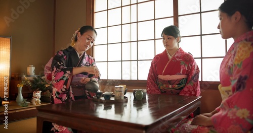 Japanese, women and matcha for tea ceremony in Chashitsu with kimono dress and traditional custom. People, temae and vintage style outfit for culture, fashion and honor with antique crockery