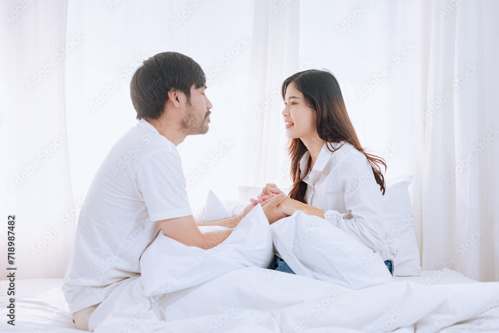 Happy love Asian young man and woman staying together in bedroom, Valentine's Day, Concept of holiday and surprise. Happy love Asian young man and woman staying together in bedroom, Valentine's Day, Concept of holiday and surprise.