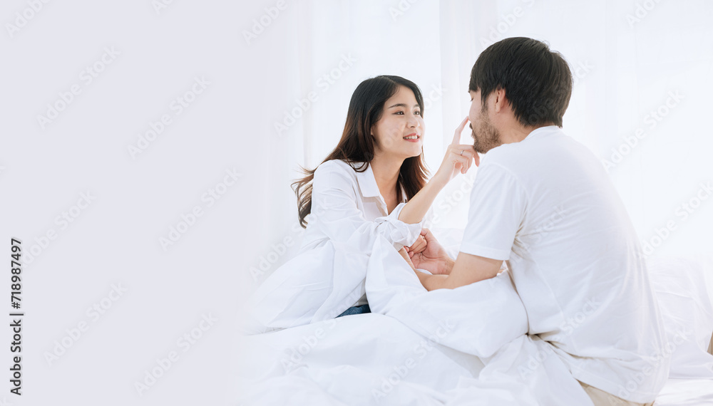 Happy love Asian young man and woman staying together in bedroom, Valentine's Day, Concept of holiday and surprise. Happy love Asian young man and woman staying together in bedroom, Valentine's Day, Concept of holiday and surprise.