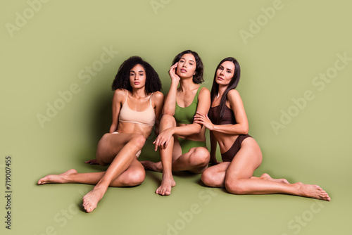 Full length studio photo of sexy slim women wear lingerie enjoying self acceptance isolated pastel khaki color background